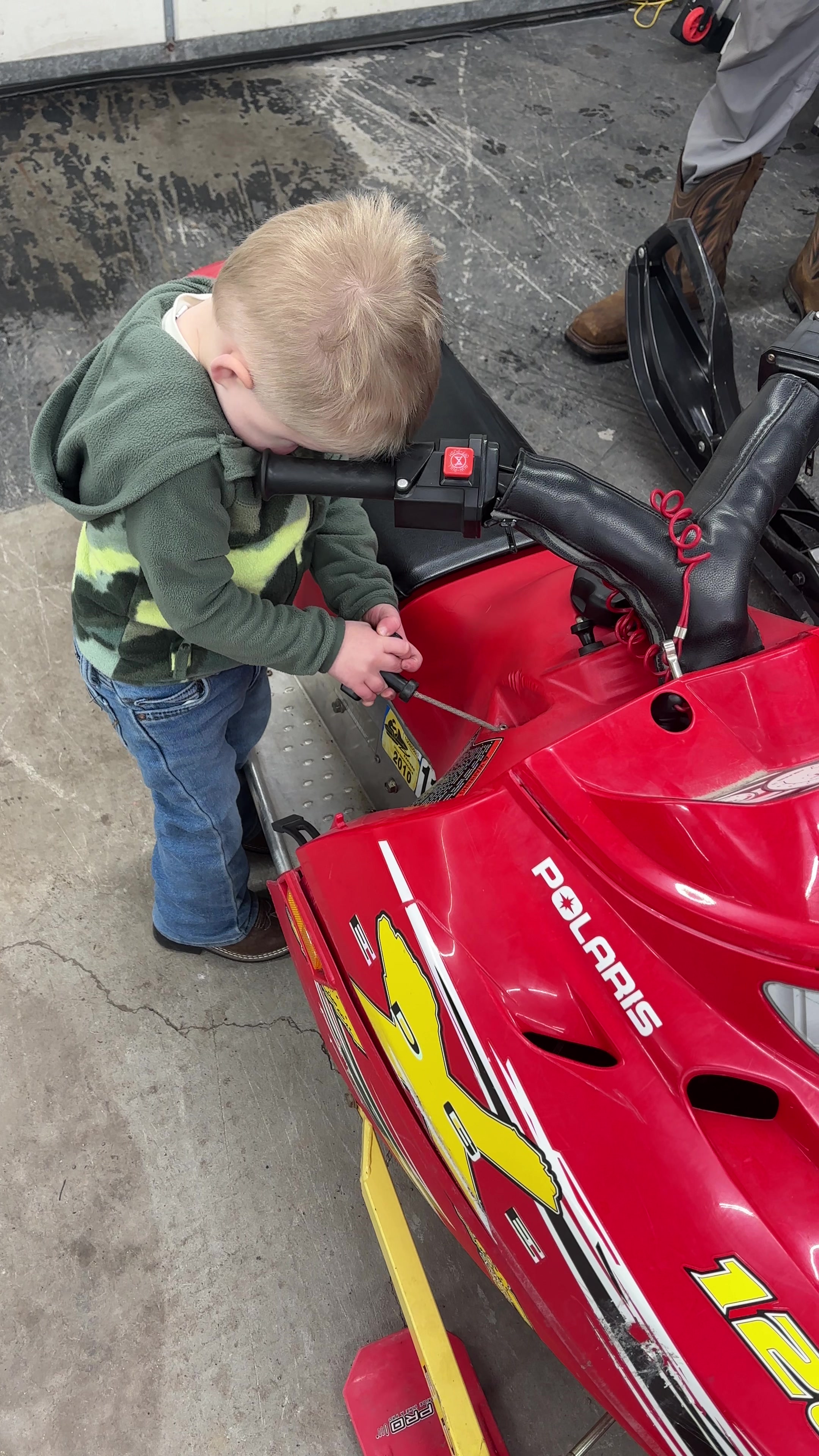 He is ready to rip! He was really pulling on it until he saw me start to video and he got shy 🤪 sorry bud! You’ll get it started here soon 😂🤘#readytoride #startthemyoung #snowmobilemom 
