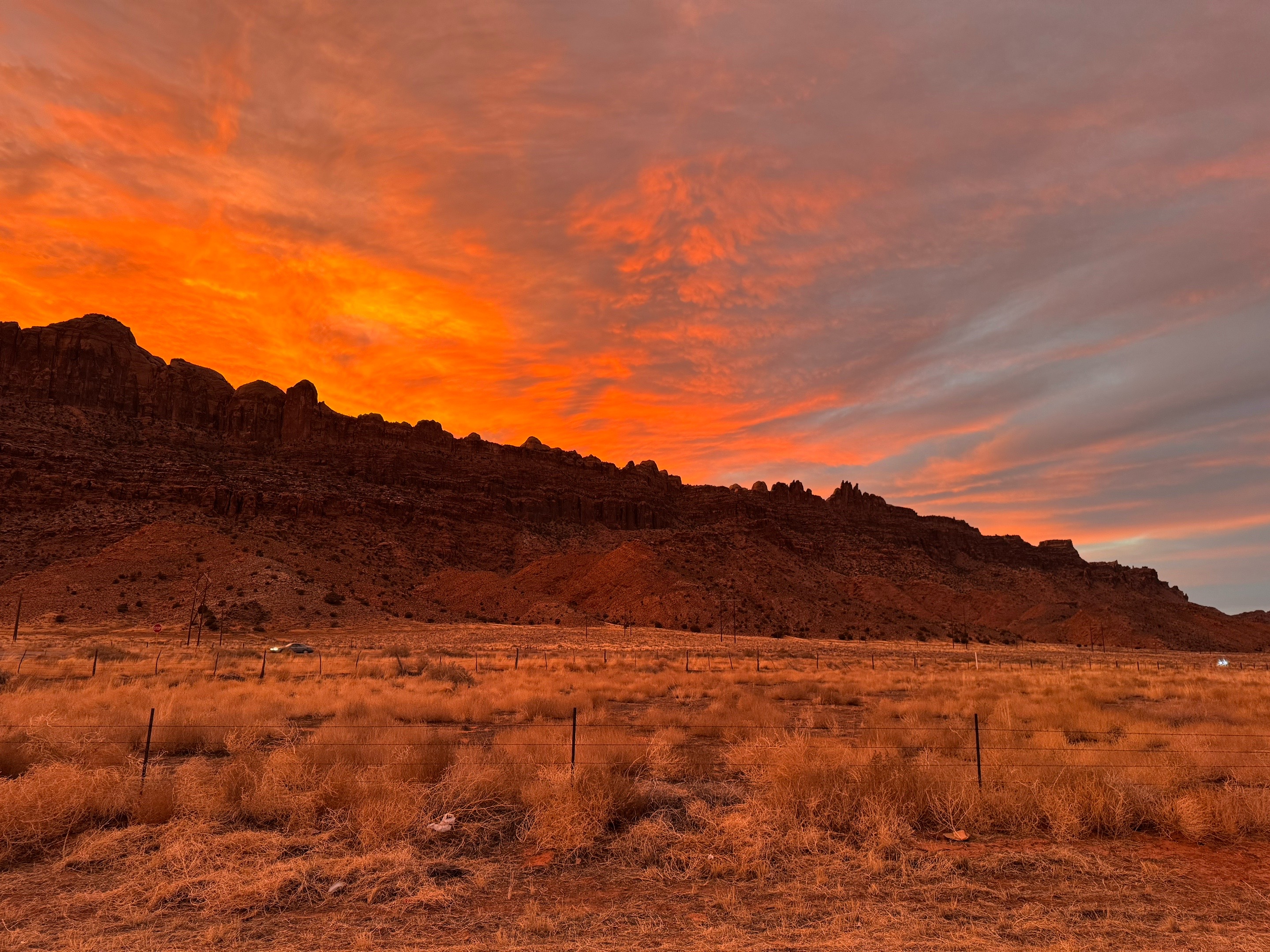 Moab sunsets aren’t famous because they’re edited, they’re famous because the landscape is perfectly built for them. At over 4,000 feet above sea level, Moab’s high-desert air is usually dry and remarkably clear. As the sun sinks toward the horizon, its light has to travel through much more of Earth’s atmosphere. Along the way, shorter blue wavelengths are scattered in every direction, allowing the longer reds, oranges, and pinks to become the colors we see. Then the red rock takes over. The cliffs surrounding Moab are rich in iron oxide, the same mineral that gives rust its color. Those rocks naturally reflect warm light, so when the evening sun hits them just right, the entire landscape seems to glow from the inside out. Every sunset is a little different. A slight change in dust, clouds, or humidity can completely transform the colors, which is why no two evenings ever look exactly alike. It’s not a filter. It’s physics, geology, and a little bit of desert magic working together.
